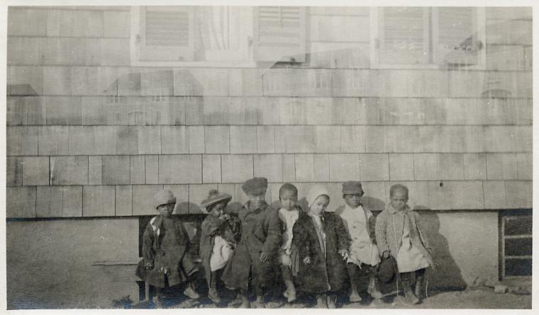 Group portrait of Howard Orphanage and Industrial School children sitting on bench