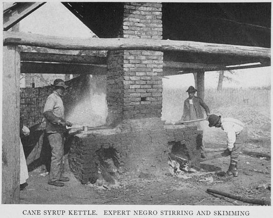 Cane syrup kettle; Expert Negro stirring and skimming.