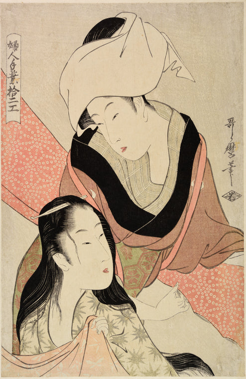 A woman stretching spotted crepe (kanoko) and talking to another woman with her hair down who is seated beside her