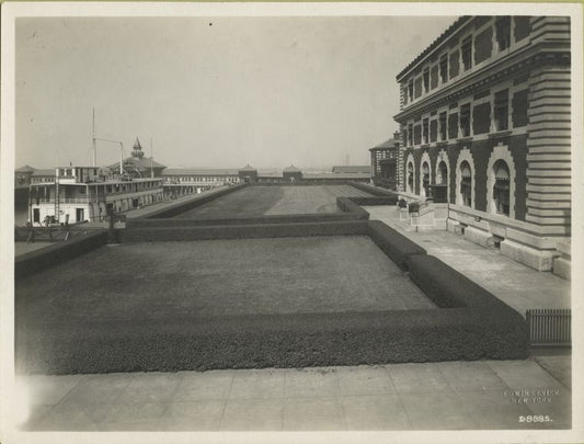 Ferry, the Laura, at Ellis Island pier; part of the Immigration Station is visible at right.