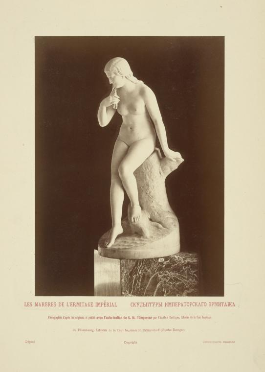 Nude woman sitting on tree trunk