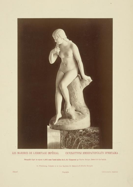 Nude woman sitting on tree trunk