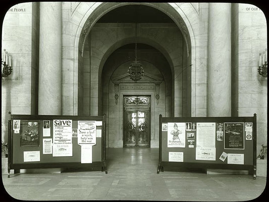 Central building, first floor lobby : looking from lobby (Astor Hall) toward exhibition hall, war posters (?) displayed on either side, ca. 1918