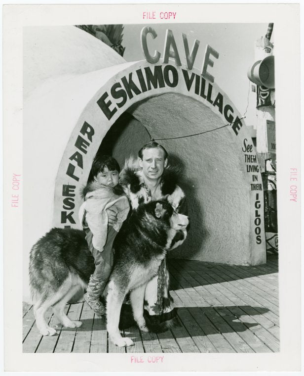 Carrier Corp. - Eskimos - Man, boy and dog outside "village".