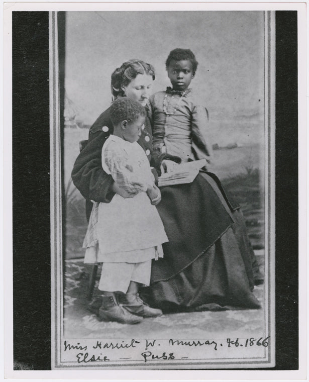 Portrait of Sea Island School teacher Miss Harriet W. Murray, with students Elsie and Puss