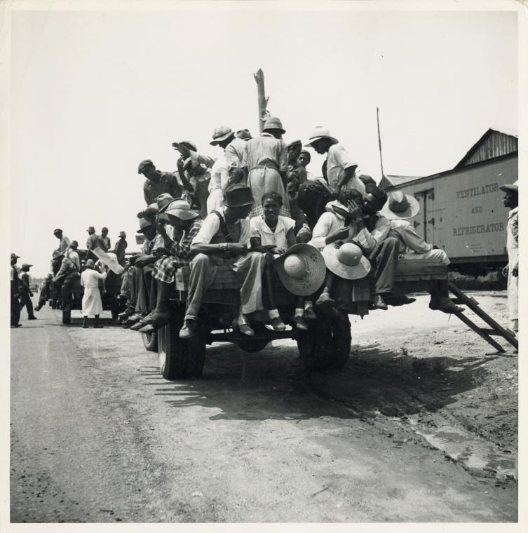 Peach pickers being driven to the orchards. They earn seventy-five cents a day. Muscella, Georgia.
