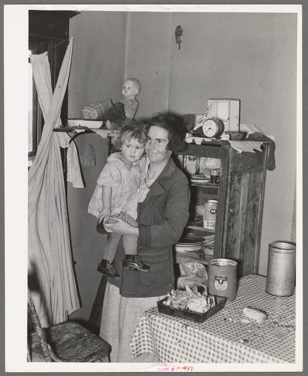 Mother and child in corner of farm home, Sheridan County, Montana