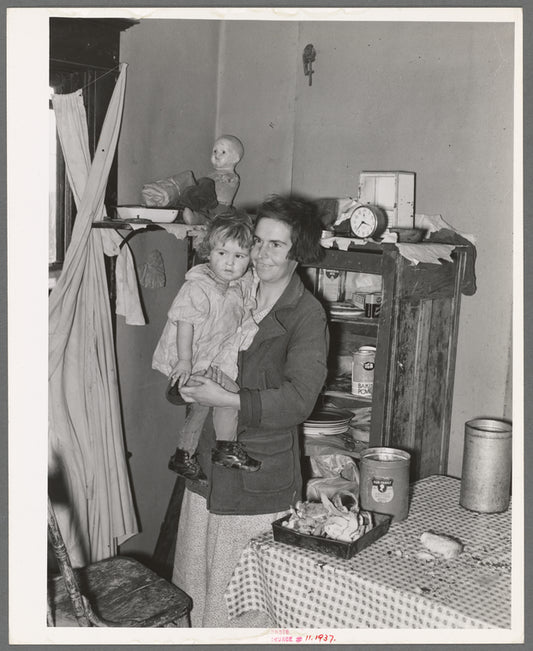 Mother and child in corner of farm home, Sheridan County, Montana