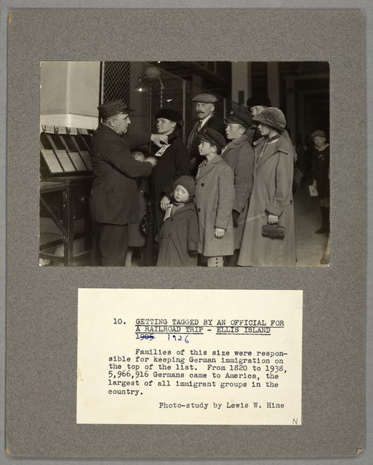 Getting tagged by an official for a railroad trip, Ellis Island, 1905