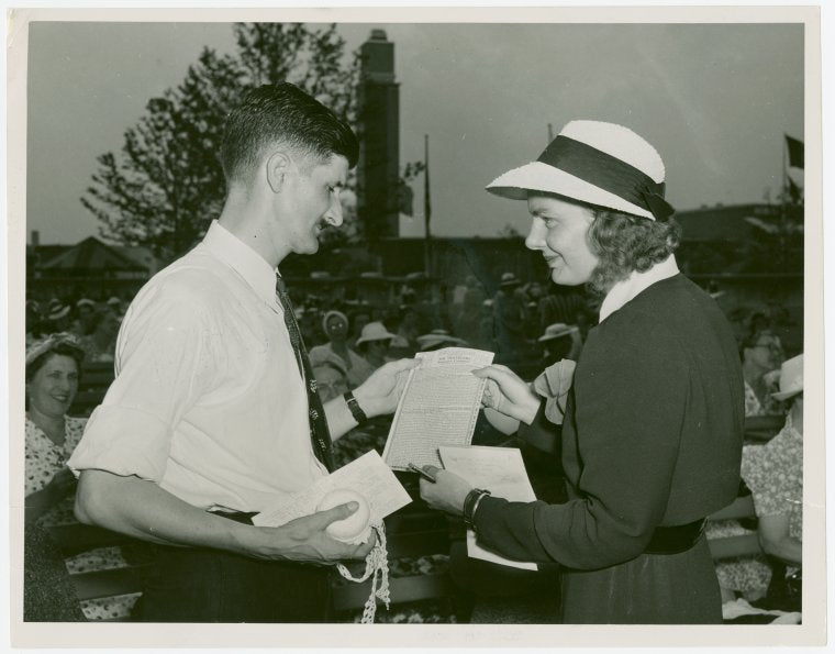 Contests - Crocheting - Contestant receiving accident policy from National Needlecraft Bureau representative