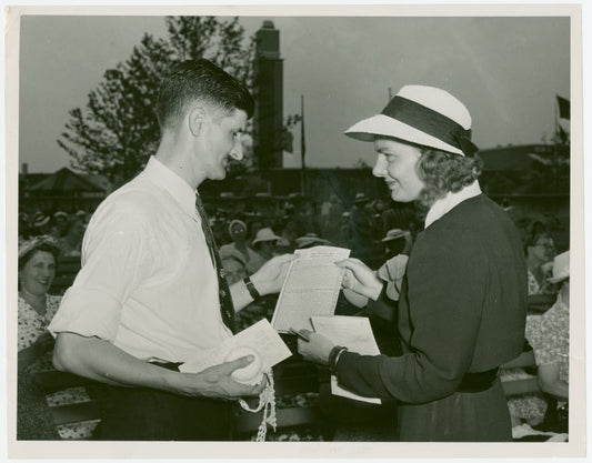 Contests - Crocheting - Contestant receiving accident policy from National Needlecraft Bureau representative