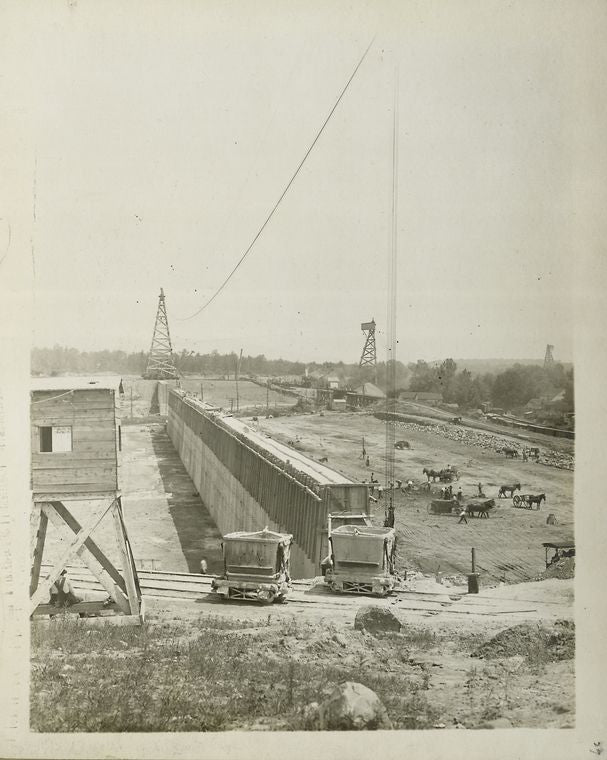 Ashokan Reservoir. View showing concrete core-wall of West dike with wooden forms in place. Placing and rolling embankment at right. Contract 3. June 21, 1910.