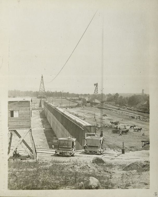 Ashokan Reservoir. View showing concrete core-wall of West dike with wooden forms in place. Placing and rolling embankment at right. Contract 3. June 21, 1910.