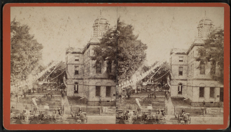 View of a domed building with decorations hanging from it.