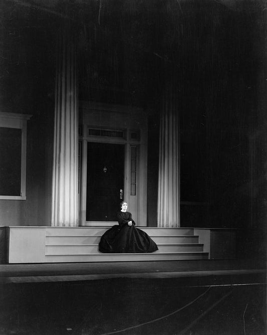 Alice Brady as Lavinia Mannon (seated on the steps of Mannon Mansion.)