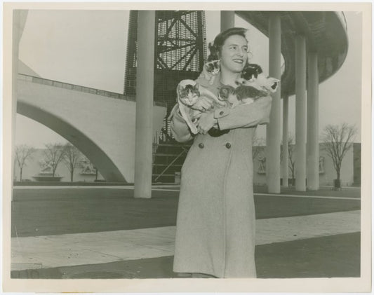 Cats - Woman holding cats at base of Trylon