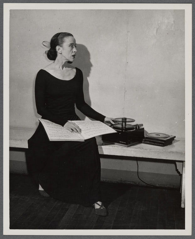 Martha Graham teaching with sheet music and a record player