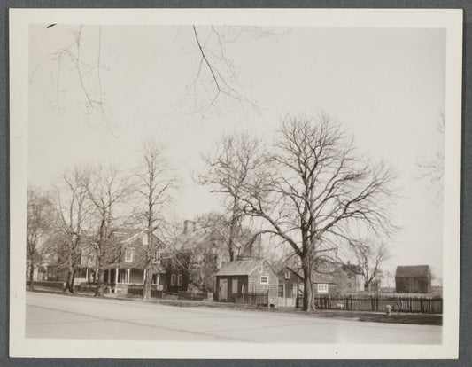 House on the left owned by Jeremiah Mulford (1858), center house owned by Laura Halleck (1924), house on right owned by Gwen Bennett (1924) and a gift shop. East side of Main St., south of David's Lane. East Hampton, East Hampton