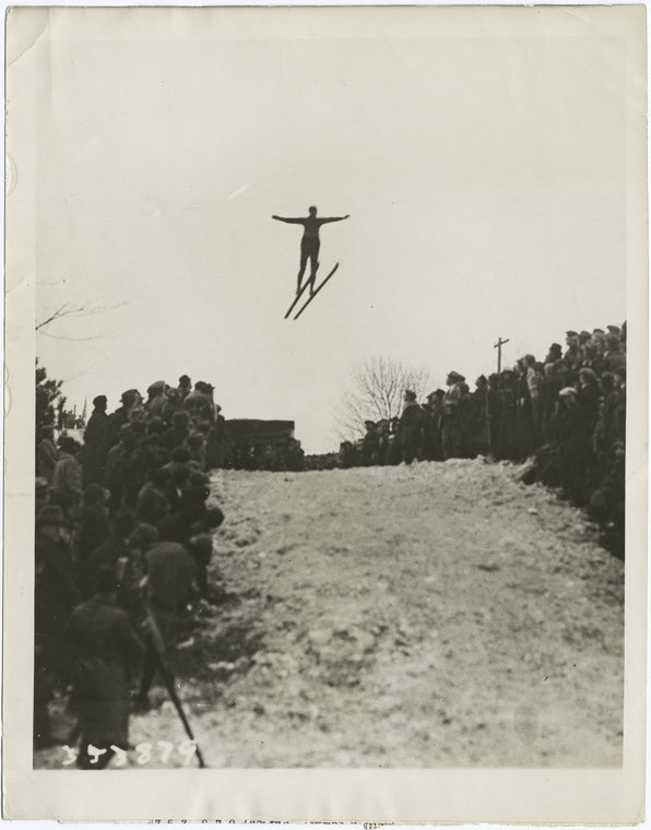 Olympian ski jumpers perform on famous $6,000 imported snow.