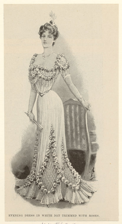 Evening dress in white net trimmed with roses