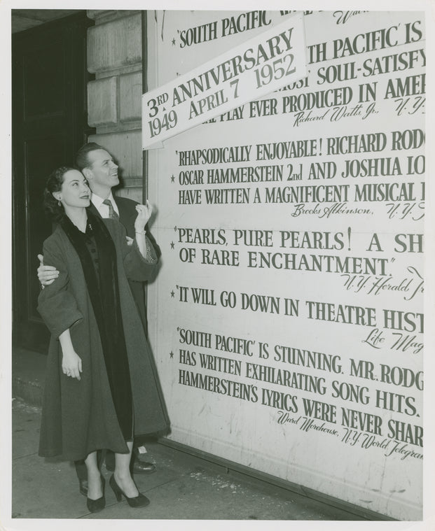 Irma Sandre (Liat replacement) and William Tabbert (Lt. Joseph Cable) at theatre billboard for South Pacific