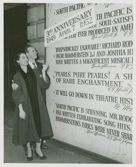 Irma Sandre (Liat replacement) and William Tabbert (Lt. Joseph Cable) at theatre billboard for South Pacific