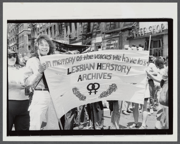 Lesbian Herstory Archives marchers with banner: Lesbian Herstory Archives