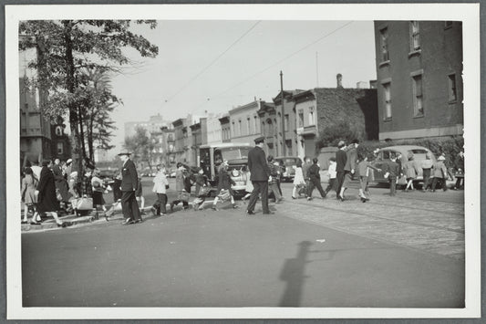 A policeman watching children crossing the street