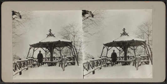 Man standing at Summer House in snow storm.
