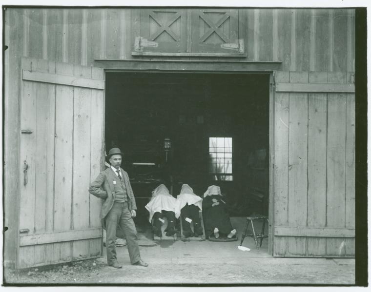 Man standing in front of victims of train wreck