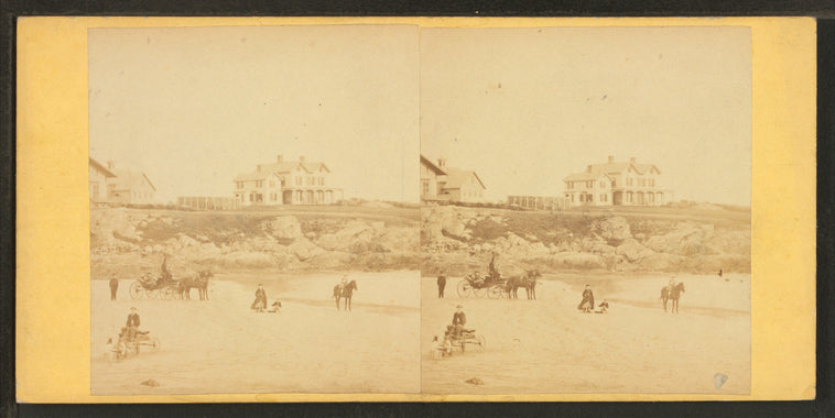 Coaches, horseback rider and people on the beach and houses in the distance.