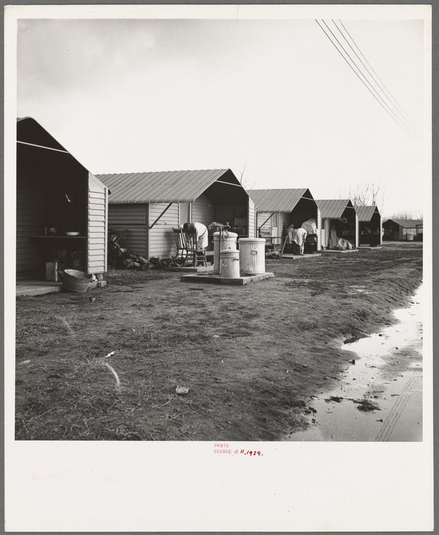 United States government camp for migrants (Farm Security Administration), Farmersville, California. Prefabricated steel dwellings "one step up from a tent" replace the use of tents in the newer California camps