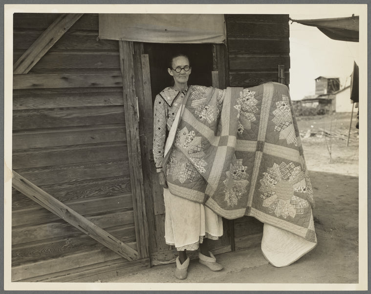 Grandmother from Oklahoma and her pieced quilt. California, Kern County