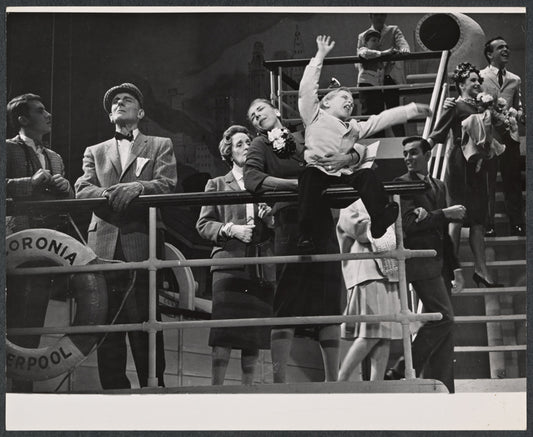 Paula Bauersmith [holding child] and unidentified others in the stage production Sail Away