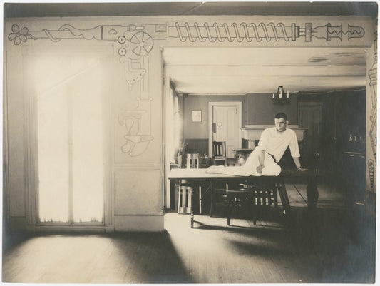 Lincoln Kirstein sitting on a table at Harvard University
