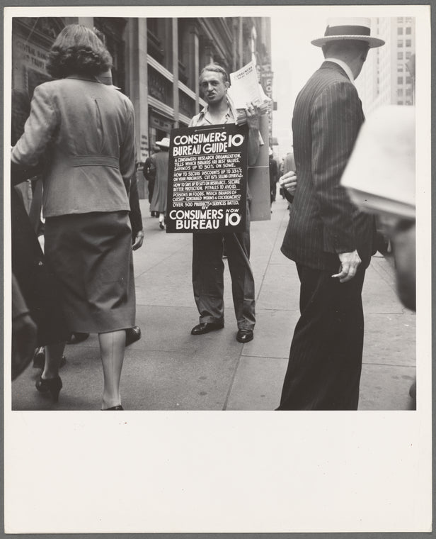 42nd Street and Madison Avenue. Street hawker selling Consumer's Bureau Guide. New York City