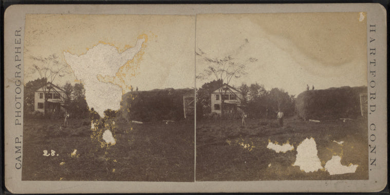 A farm scene showing men stacking hay.