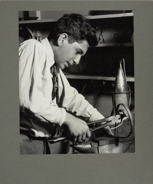 A boy making a wrought iron lamp in a Brooklyn school, 1925