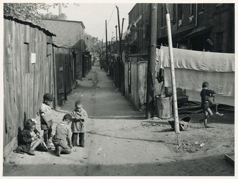 Children playing in the Defrees Alley, NE Washington, D.C.; Near Capitol Building; One basement room rents for $9.00 a month, two rooms upstairs for $ 16.00, one bath and cold water in the hall for entire building.