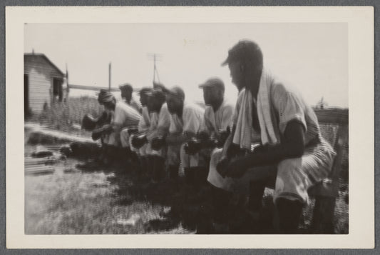 Men in baseball uniforms on bench