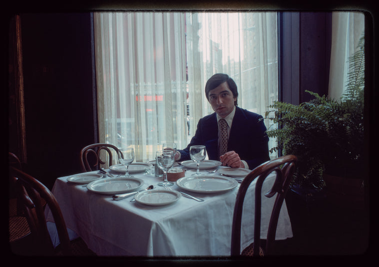 Man seated at dining table, 1057 Restaurant