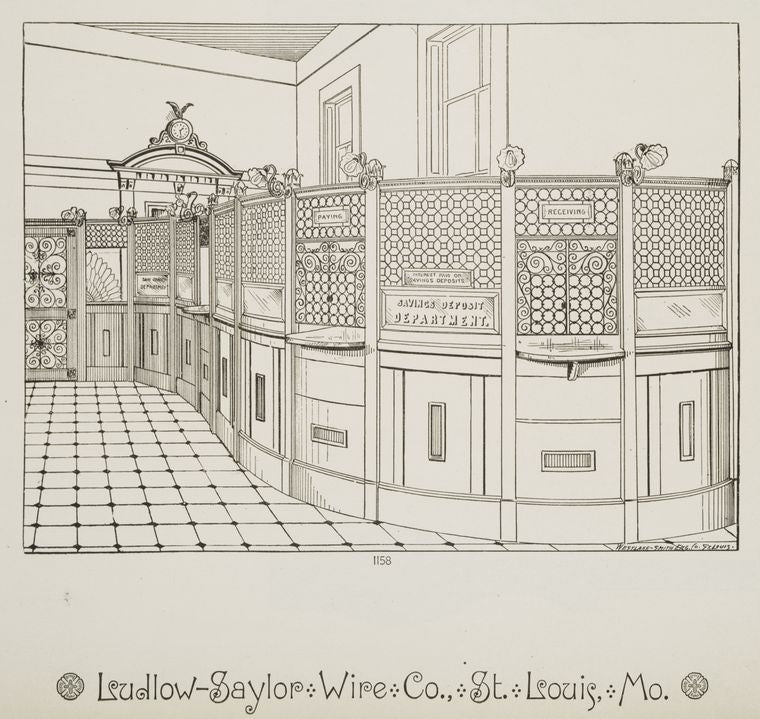 Interior of a bank with decorative metalwork sconces, plaques, and grille.