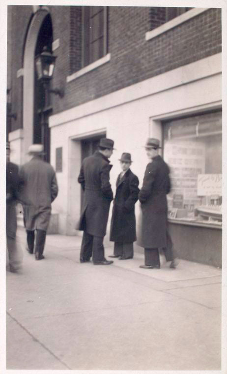 Exterior, men looking in at window display