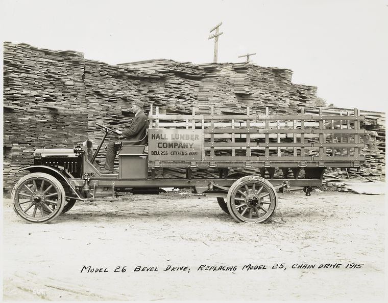 Model 26 Bevel drive; replacing Model 25, chain drive 1915. [At the loading site of Hall Lumber Company].
