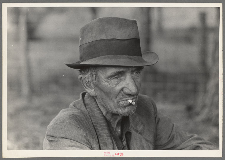 Migrant worker resting along roadside, Hancock County, Mississippi