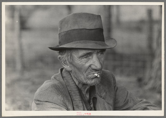 Migrant worker resting along roadside, Hancock County, Mississippi