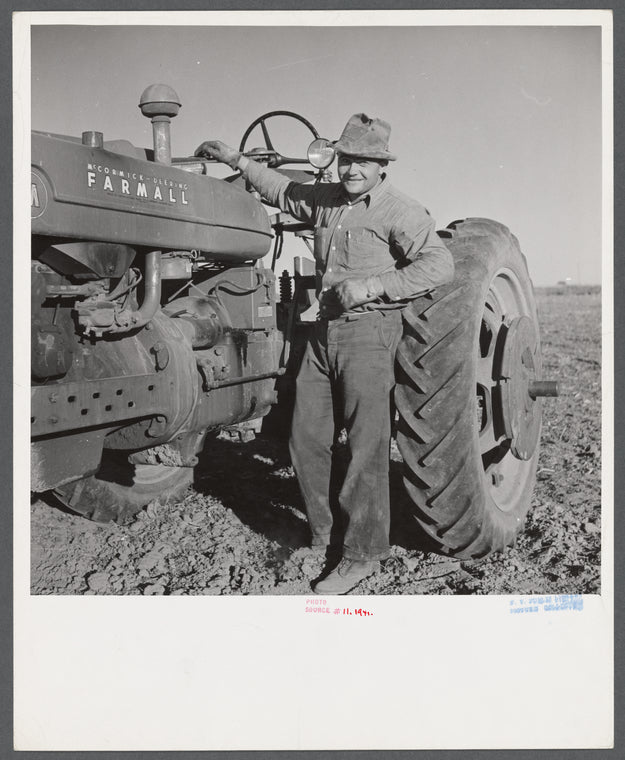 Scottsbluff homesteads, a FSA (Farm Security Administration) cooperative project in Nebraska. Frank E. Hagemeister, treasurer of the cooperative project, beside his tractor.