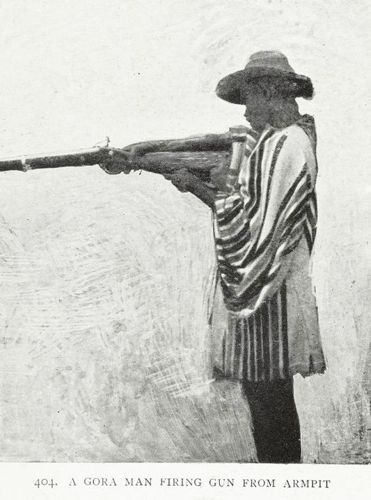 A Gora man firing gun from armpit.