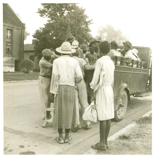 Cotton hoers leaving Greenville at 5 a.m. for a day's work on the plantations; Wages one dollar a day, one dollar and twenty-five cents on a few plantations; Hoers carry their lunches; They return about 8 p.m. Mississippi.