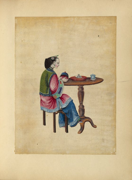 Woman seated at a round table